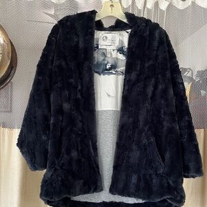 Tiny editions over coat